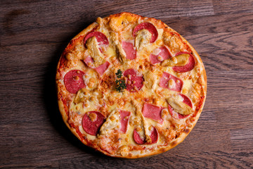 Pizza with ham and sausages