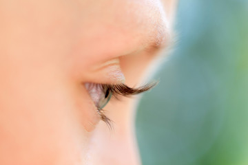 Closeup of an eye of the young girl, profile view