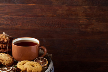 Cookies with cinnamon and two cups of tea on a burlap napkin, selective focus, close-up, top view.