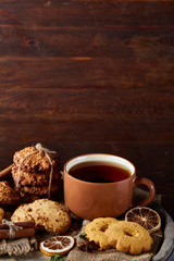 Cookies with cinnamon and two cups of tea on a burlap napkin, selective focus, close-up, top view.