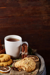 Cookies with cinnamon and two cups of tea on a burlap napkin, selective focus, close-up, top view.