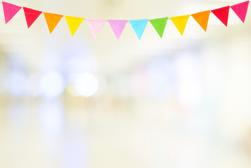 Colorful party flags hanging on blur abstract background, birthday, anniversary, celebrate event,...