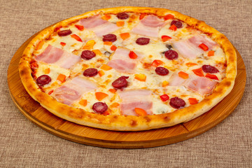 Pizza with ham and sausages