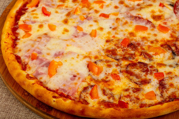 Pizza with ham and sausages