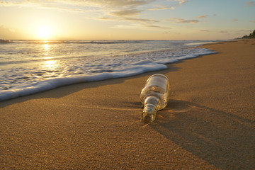 Glass bottle with beatiful beach sunset landscape