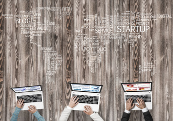 Top view of businesspeople sitting at table and using gadgets