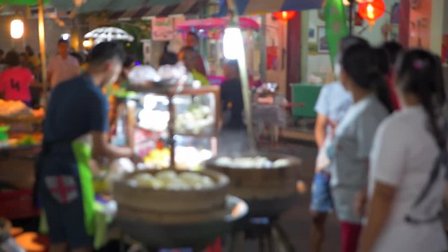 4K Timelapse Movie Thai Local Vendors Selling Food and Clothes at Famous Sunday Night Market in Songkhla Old Town. Tourists Walking and Shopping. Songkhla, Thailand - 14/07/2018.