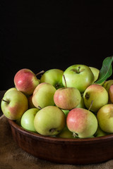 Ripe red and green apples on wooden background. Apples in bowl. Garden fruits. Autumn fruits. Autumn harvest.