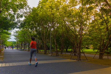 Fototapeta na wymiar young fitness sports woman runner running on tropical park