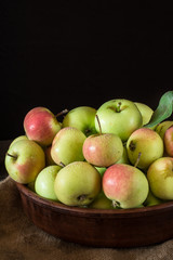 Ripe red and green apples on wooden background. Apples in bowl. Garden fruits. Autumn fruits. Autumn harvest.