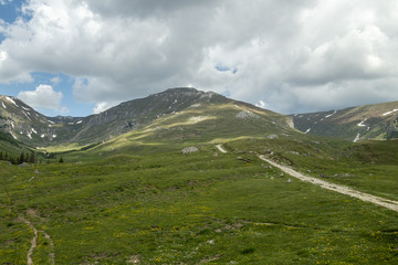 View of Bucegi Mountains, Bucegi National Park, Romania, clear blue sky, few clouds, sunny summer day, perfect for hiking