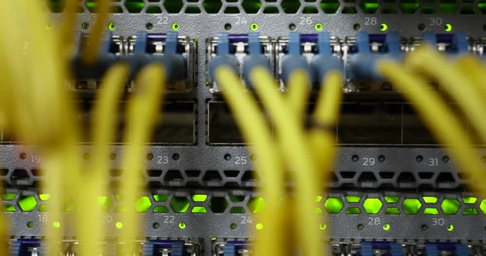 Details of a storage array in a modern data center with lot of connectors and blinking leds