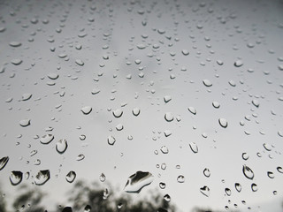 Large drops of rain on the windshield of the car
