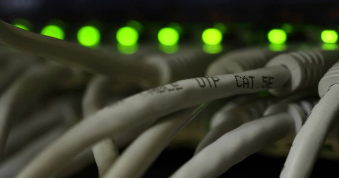 Details of a storage array in a modern data center with lot of connectors and blinking leds