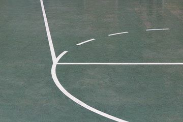 Green basketball court and lines on an outdoor