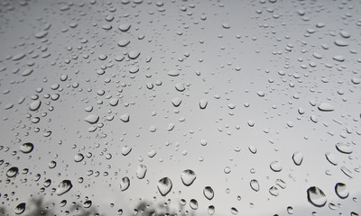 Large drops of rain on the windshield of the car