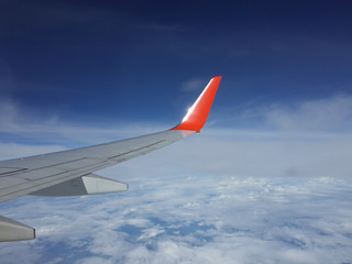View of an airplane wing from window Seat flying above the clouds