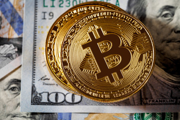 golden bitcoin coin on us dollars close up. Electronic crypto currency