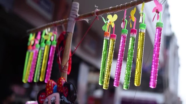 Slow motion of colorful toys of a street hawker in India