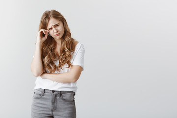Girl is crying from misfortune. Upset gloomy attractive girlfriend with blond hair, taking off...