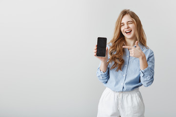 Best choice ever. Portrait of good-looking caucasian female model with blond hair in blue blouse,...