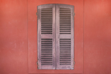 Old wood window with orange walls.