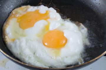 Two fried eggs in a pan