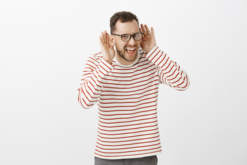 What cannot hear you. Portrait of uncomfortable intense handsome adult with bristle in glasses,...