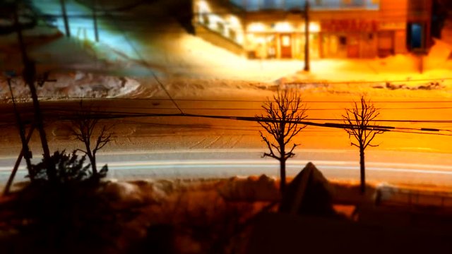 Miniature timelapse of snowy street at night