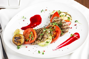 Grilled meat with vegetables, zucchini, mushrooms, tomatoes, onion and sauce
