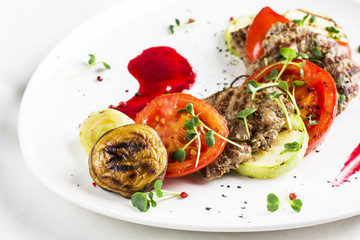 Grilled meat with vegetables, zucchini, mushrooms, tomatoes, onion and sauce