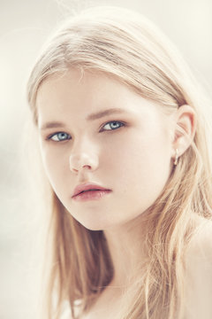 portrait of a girl with blond hair in a high key