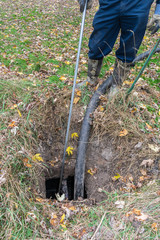 Worker pumping out a home septic tank