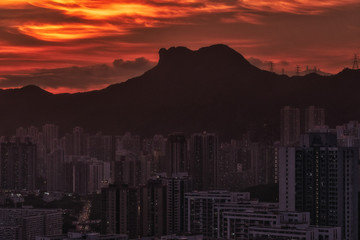 Kowloon Residential Building and Urban Skyscrapers Under Mountains Lion Rock Summer Sunset Landscape with Dramatic Sky