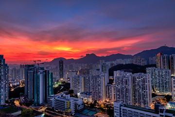 Kowloon Residential Building and Urban Skyscrapers Under Mountains Lion Rock Summer Sunset Landscape with Dramatic Sky