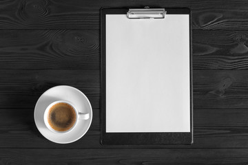 the white open notepad and computer keypad, mouse, mobile, coffee isolated on the wooden desktop