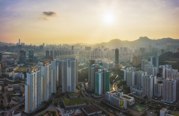 Fototapeta na wymiar Kowloon Residential Building and Urban Skyscrapers Under Mountains Lion Rock Summer Sunset Landscape with Dramatic Sky