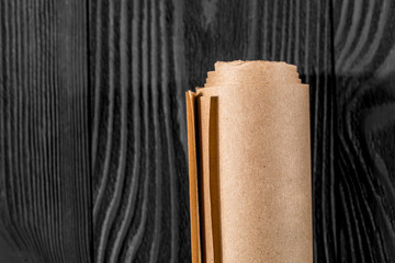 yellow kraft paper isolated on a black wooden background