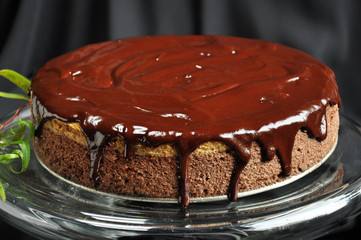 Mocha cheesecake with chocolate glaze on a glass plateau