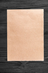 yellow kraft paper isolated on a black wooden background