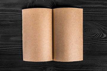 yellow kraft paper isolated on a black wooden background