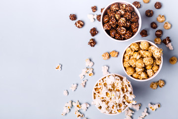 Sweet and salted popcorn on a blue background - obrazy, fototapety, plakaty