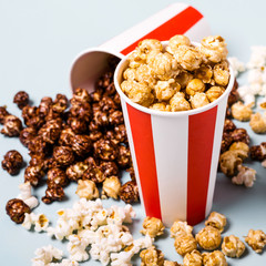 Assorted popcorn set in paper striped white red cup. Sweet and salty popcorn