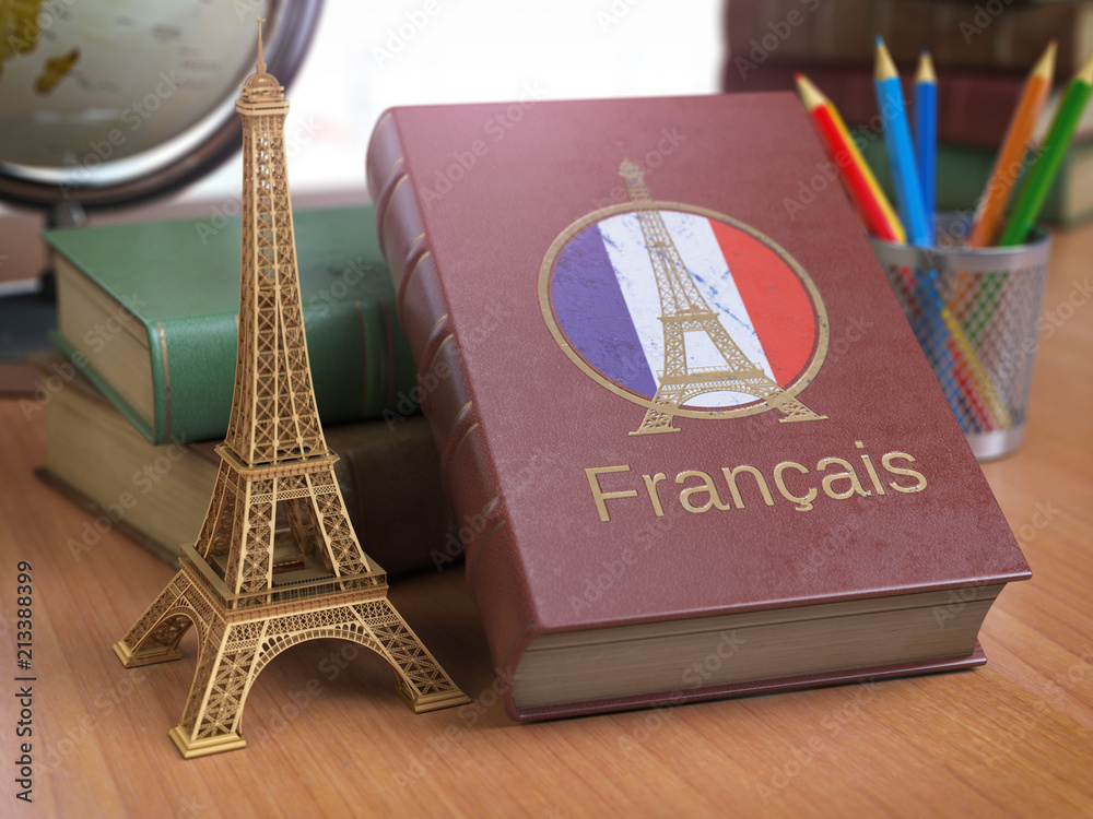 Poster Learn and studiyng French concept. Book with  French flag and Eiffel tower on the table.