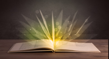 Yellow lights spreading from an open book 