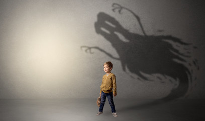 Scary ghost shadow in a dark empty room with a cute blond child
