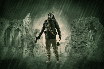 Hazard, menace man in a ruined crumbly building with arms on his hand
