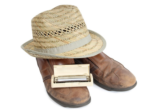 Harmonica and straw hat on a white background