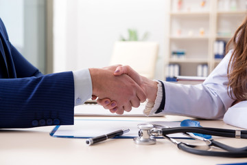 Man signing medical insurance contract