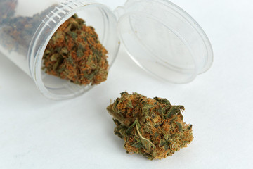Close up of prescription and recreational indica medical marijuana isolated on monochrome background